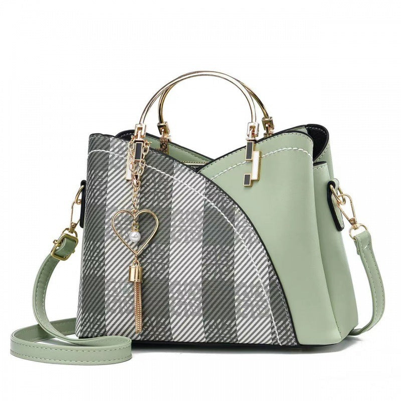 Handbag with plaid pattern and green accents on a white background