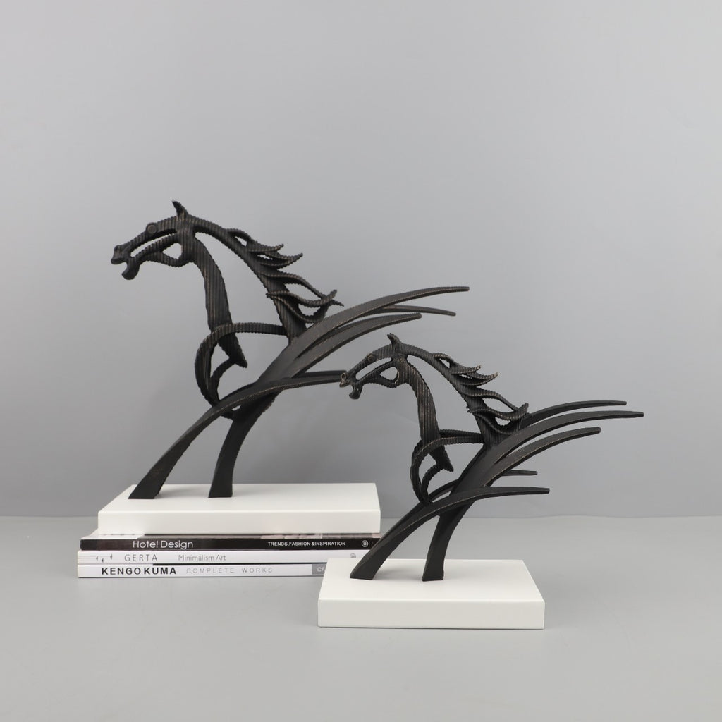 Black metal horse sculpture on a gray background