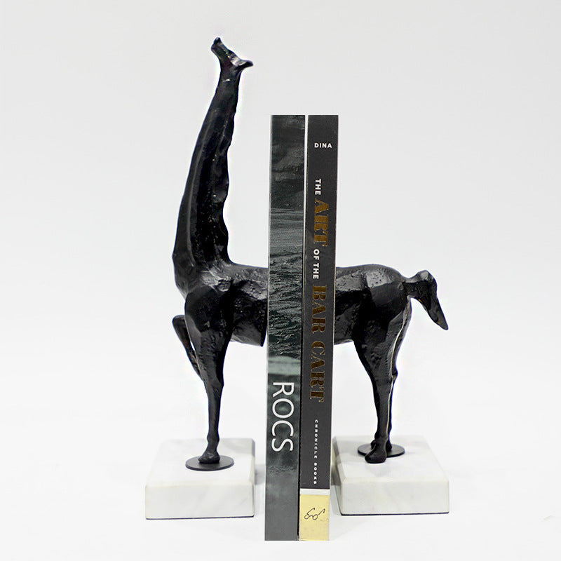 Black animal-shaped bookends holding books on a white background