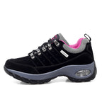 Black and gray sneaker with pink lining on a white background