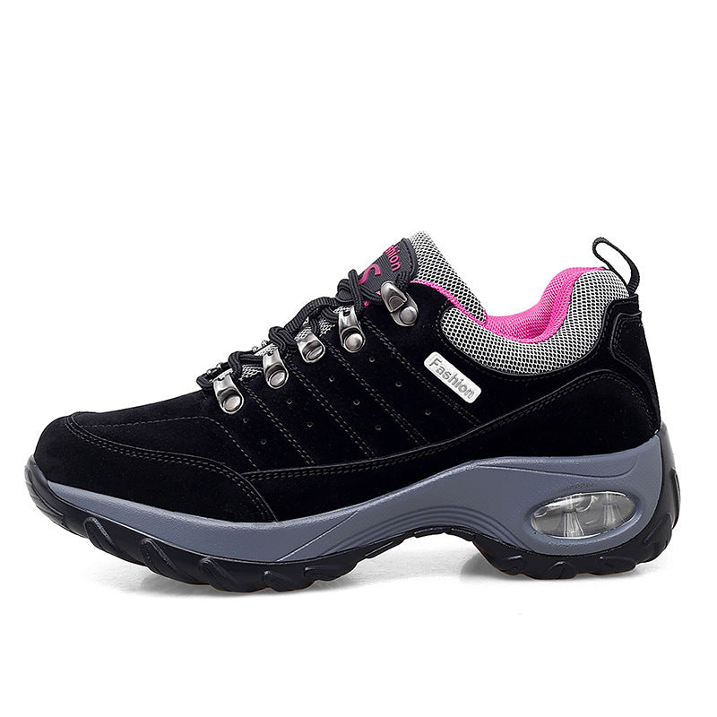Black and gray sneaker with pink lining on a white background