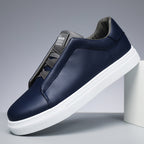 Navy blue sneaker with white sole on a gray background