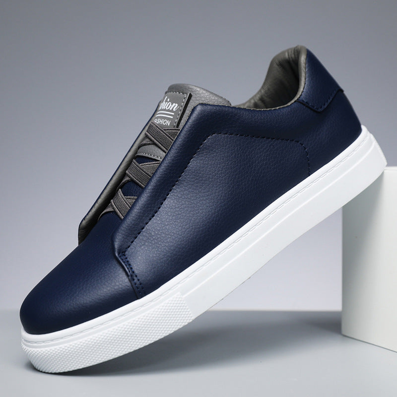 Navy blue sneaker with white sole on a gray background