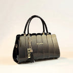 Black handbag with gold accents on a light background