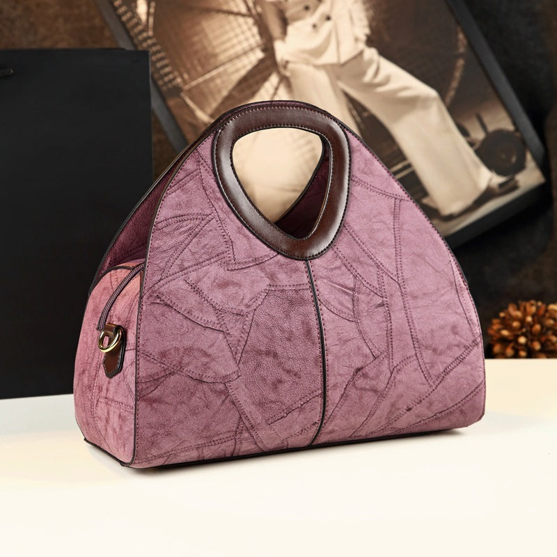 Pink textured handbag on a table with a blurred background