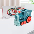 Toy train with a box of track pieces on a white surface