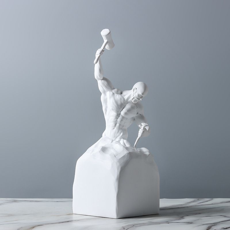 White sculpture of a muscular figure on a gray background
