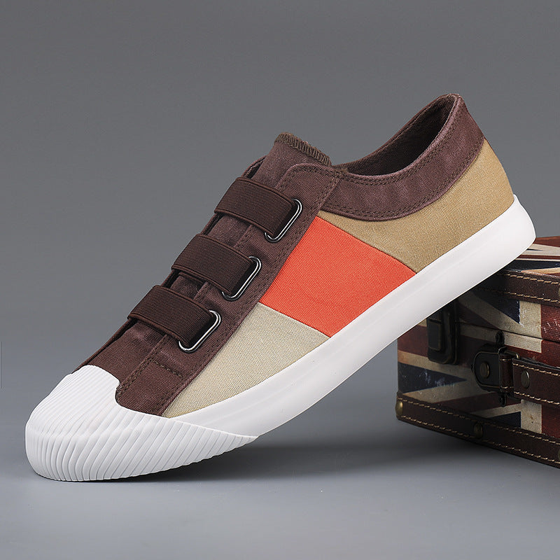 Multicolored sneaker with brown, beige, and orange sections on a gray background