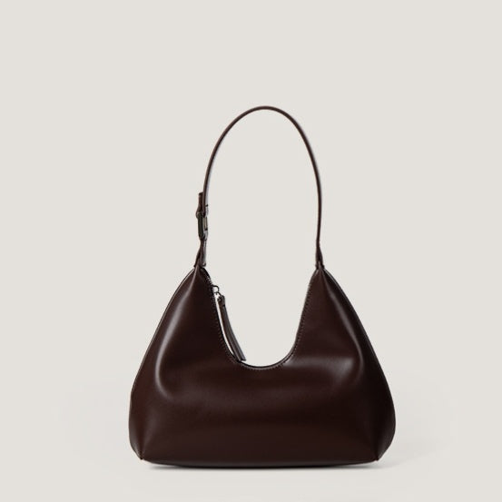 Brown leather handbag on a light beige background