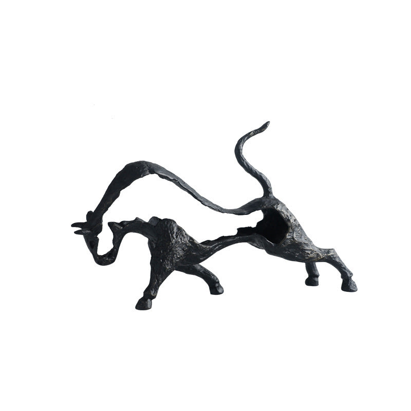 Black abstract sculpture of a cat on a white background
