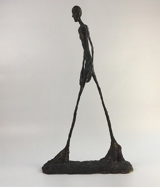 Abstract sculpture of a human figure on a white background