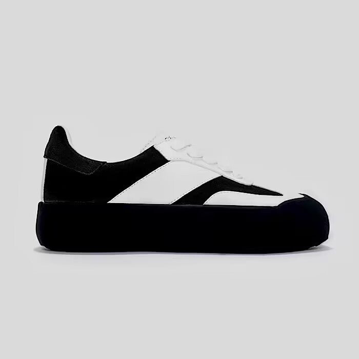 Black and white sneaker on a light gray background