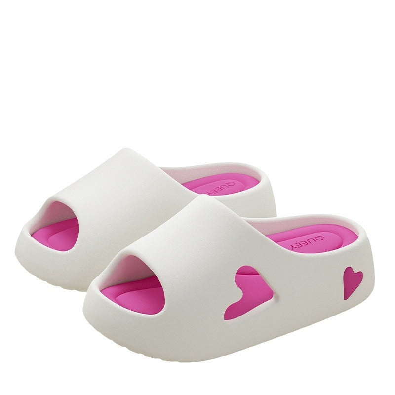 White sandals with pink hearts on a white background