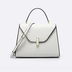 White handbag with black accents on a light gray background