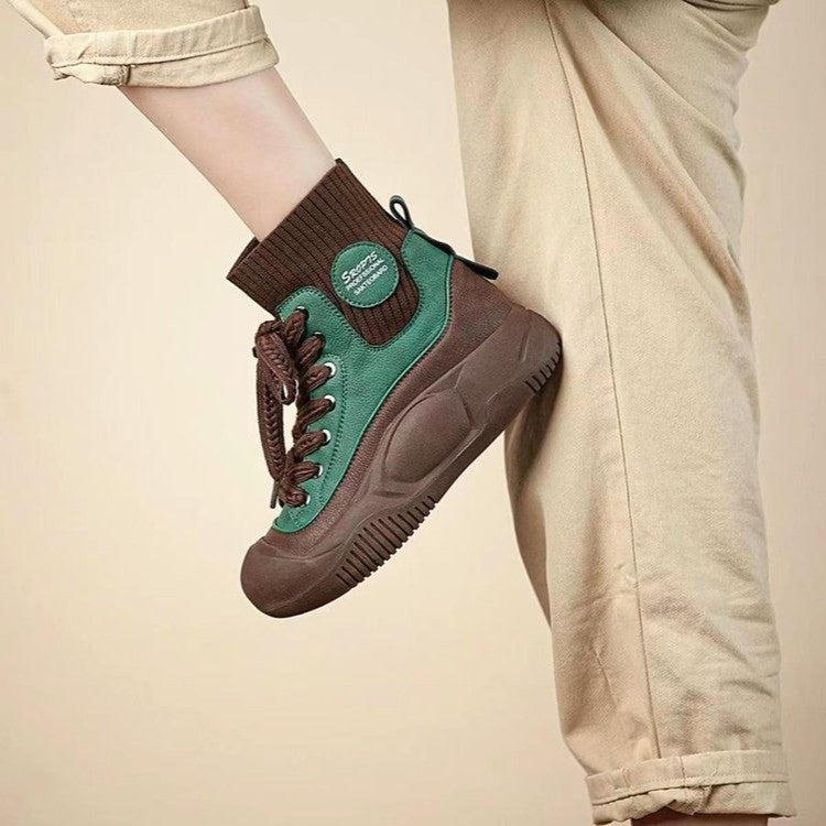 Brown and green sneaker worn by a person on a beige background