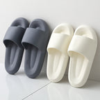 Pair of gray slides and a pair of white slides on a light gray background