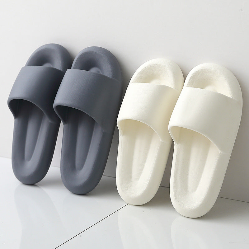 Pair of gray slides and a pair of white slides on a light gray background