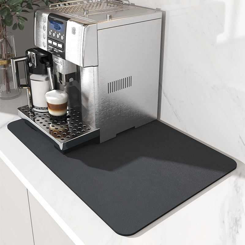 Espresso machine on a kitchen counter with a black mat underneath