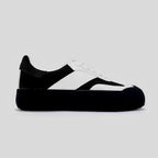 Black and white sneaker on a light gray background