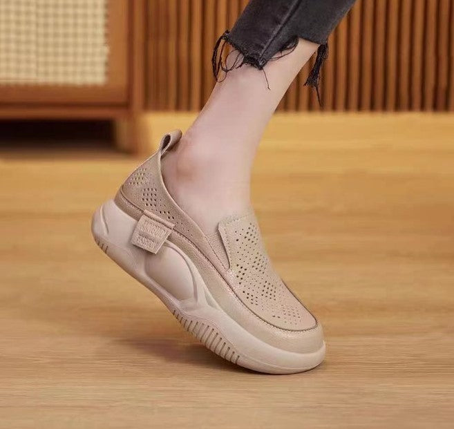 Beige slip-on shoe on a wooden floor