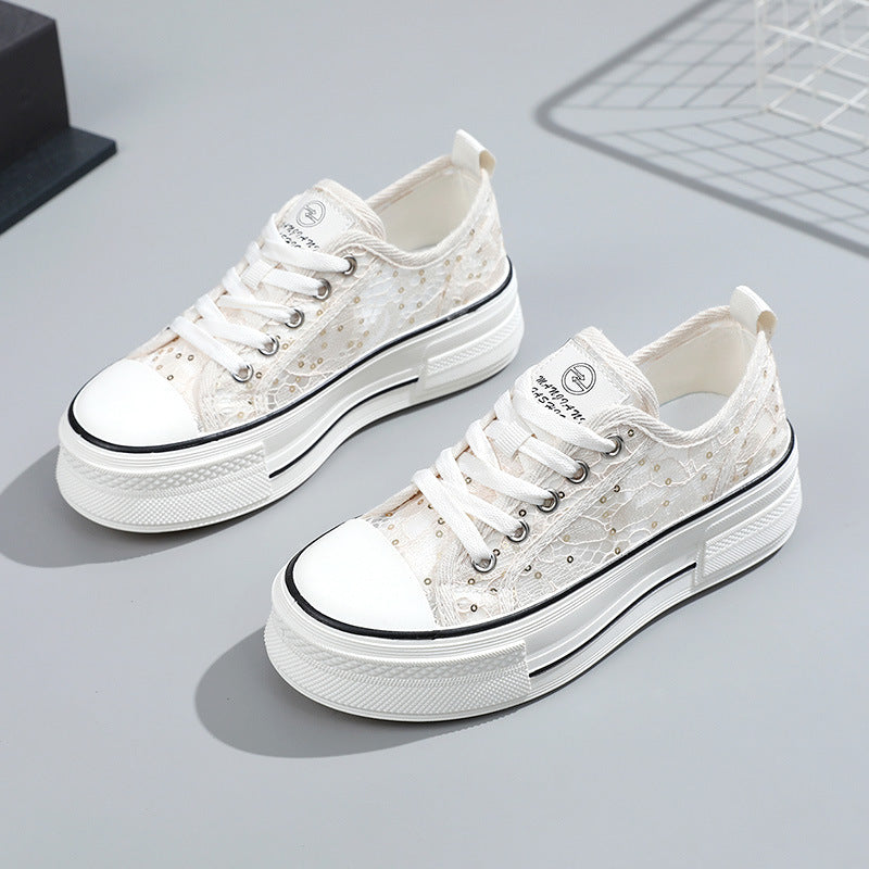 White sneakers with black accents on a light gray background