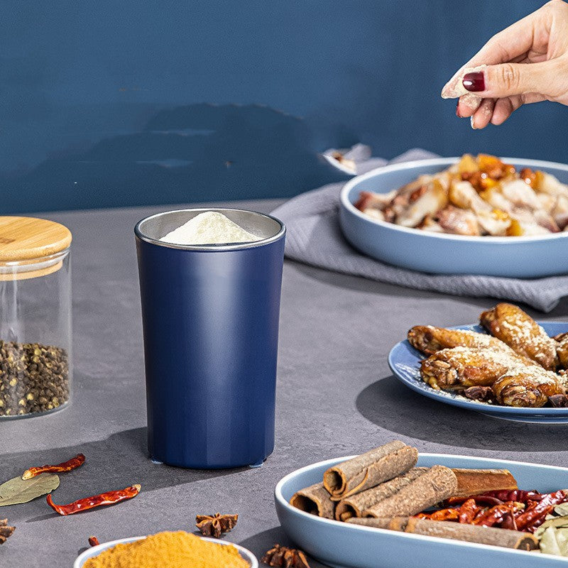 Blue container on a table with food and spices