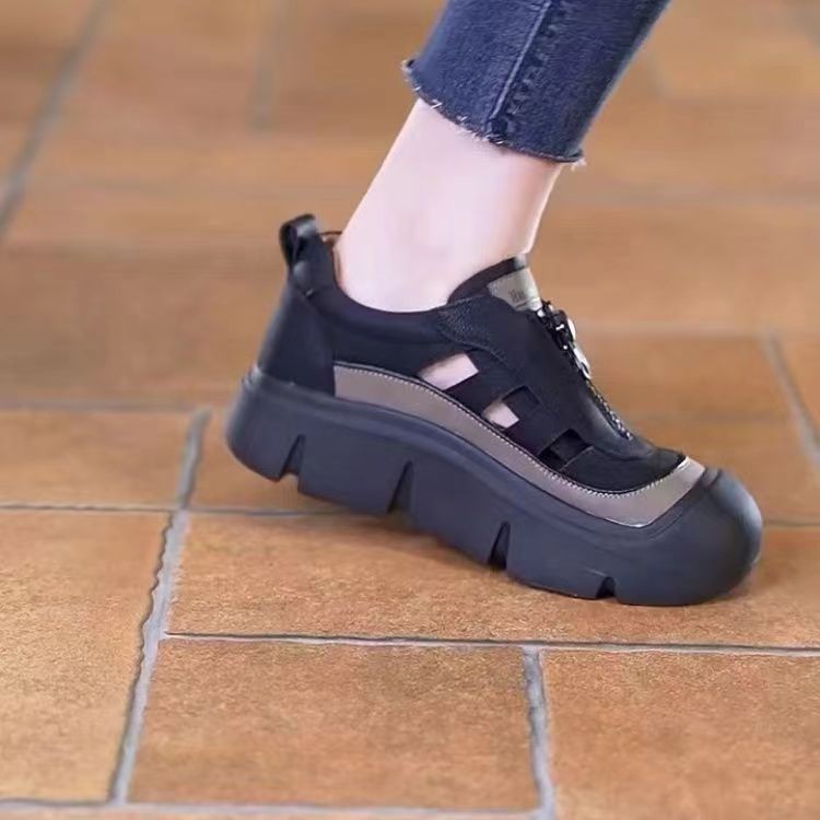Black and gray sneaker on a tiled floor