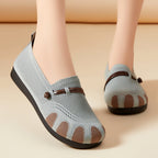 Light blue shoes with brown accents worn by a person on a beige background