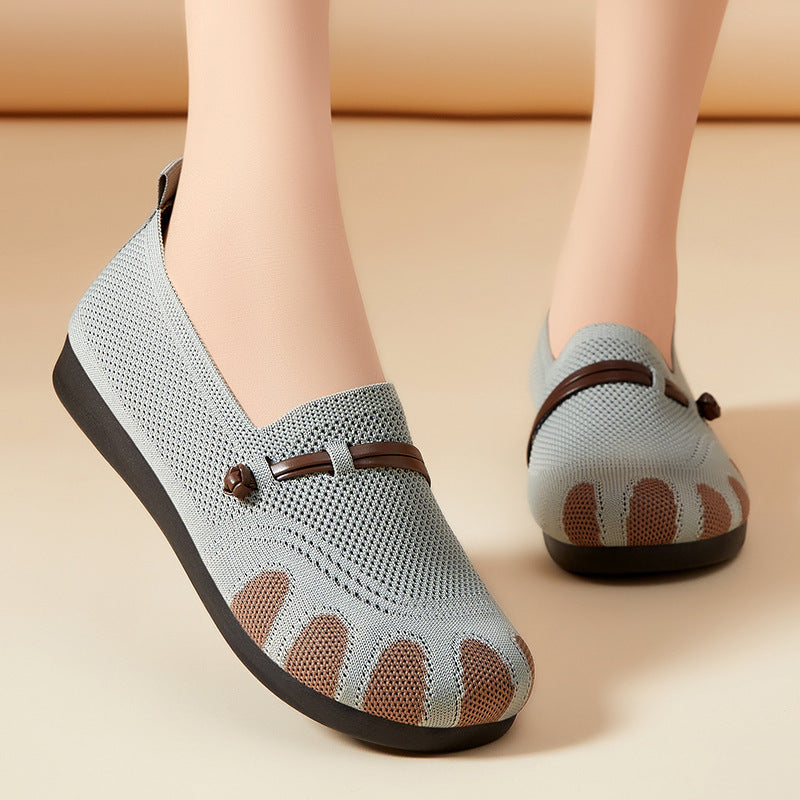 Light blue shoes with brown accents worn by a person on a beige background