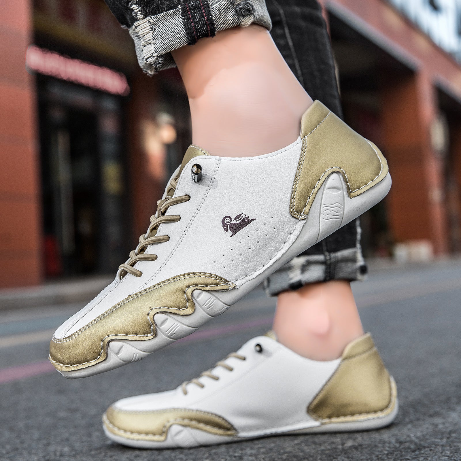 White and beige sneakers worn on a blurred street background