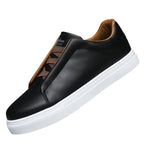 Black leather sneaker with brown accents on a white background