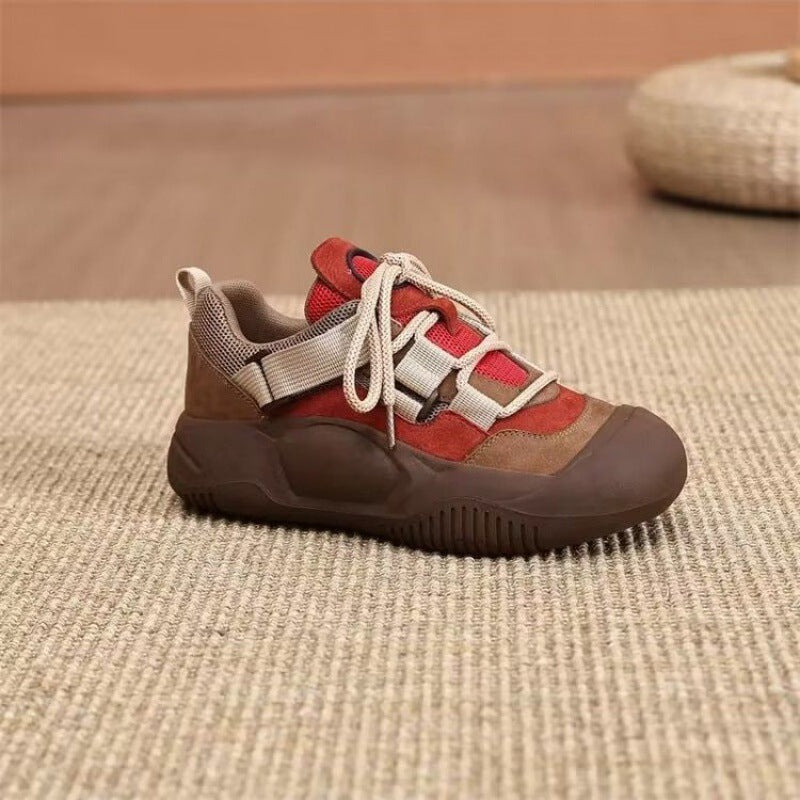 Red and brown sneaker on a textured surface