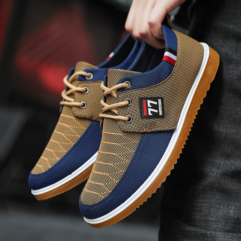 Brown and blue sneakers with a visible brand logo held by a person.