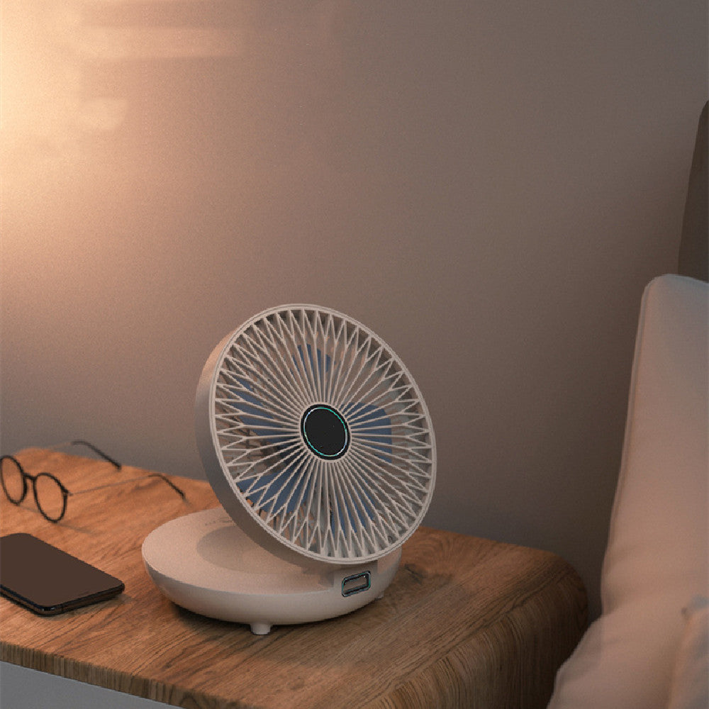 White desk fan on a wooden surface with a phone and glasses in the background