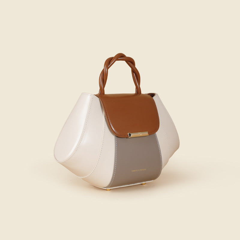 Handbag with white, brown, and gray color scheme on a beige background