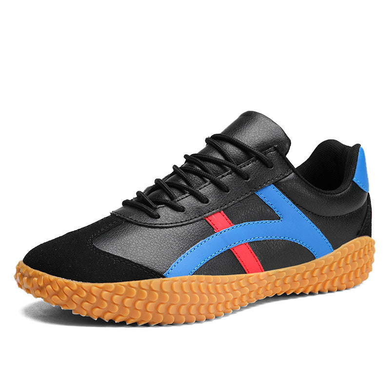 Black sneaker with blue and red accents on a white background