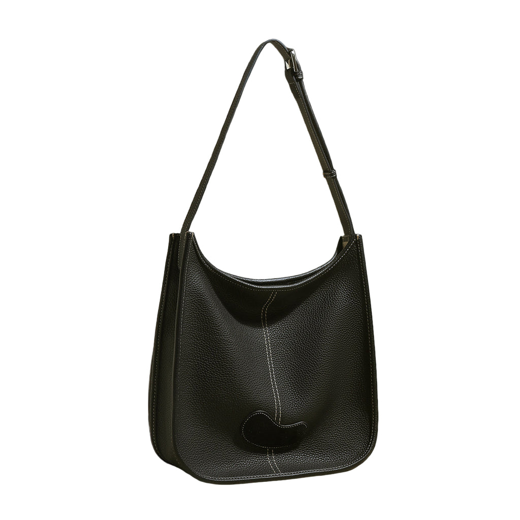 Black leather handbag on a light gray background