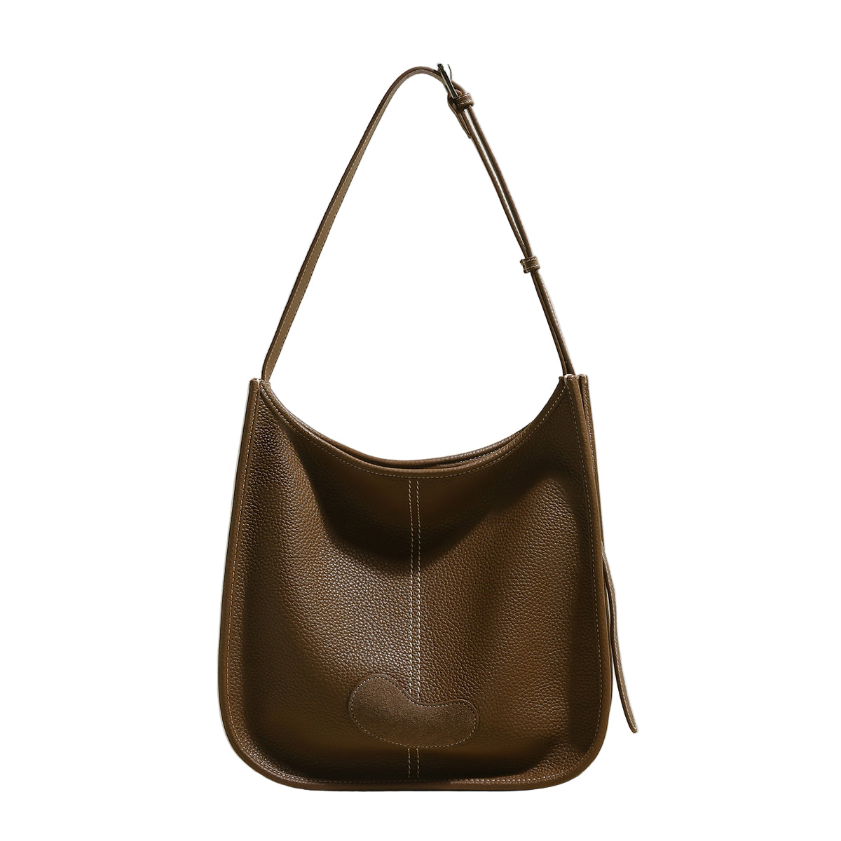 Brown leather handbag on a light background